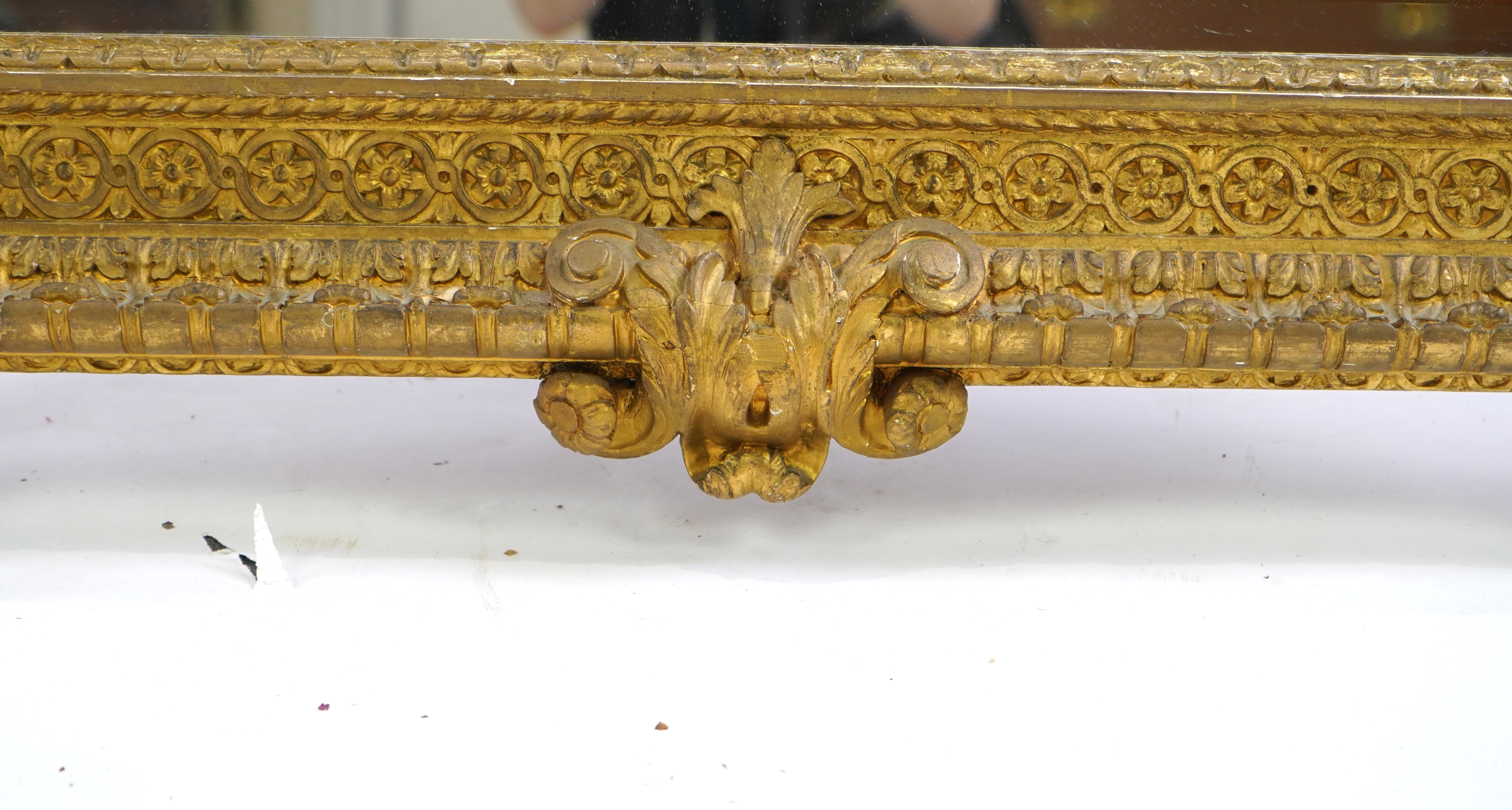 A late 19th century French carved gilt wood and composition overmantel mirror